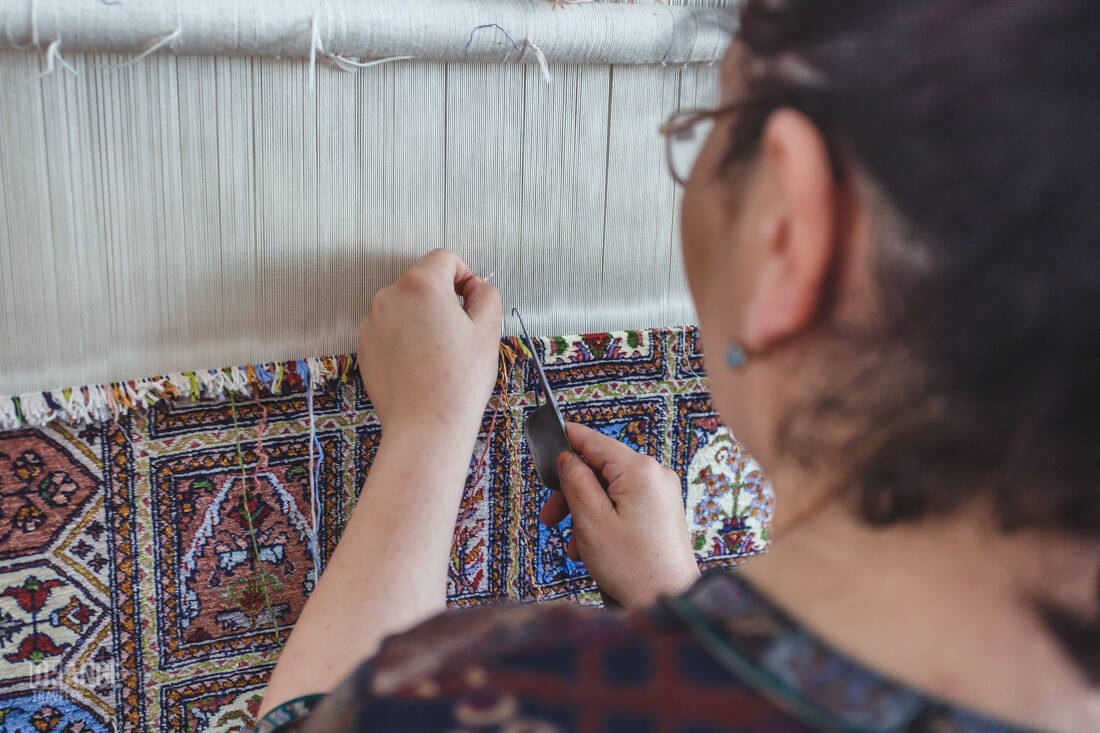 A craftswoman weaving a carpet in Samarkand